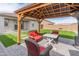 Backyard gazebo with patio seating and table, next to artificial turf, with a swing set in the distance at 19407 W Pierson St, Litchfield Park, AZ 85340