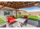 Backyard gazebo with a patio seating and table, and a barbeque grill next to artificial turf at 19407 W Pierson St, Litchfield Park, AZ 85340