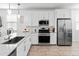 Bright kitchen featuring white cabinets, stainless steel appliances, and a large island at 19407 W Pierson St, Litchfield Park, AZ 85340