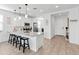 Bright kitchen with white cabinets, stainless steel appliances, and an island with seating at 19407 W Pierson St, Litchfield Park, AZ 85340