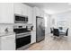 Modern kitchen with stainless steel appliances and white cabinetry at 19407 W Pierson St, Litchfield Park, AZ 85340