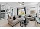 Cozy living room with tile floors, neutral furniture, and backyard access at 19407 W Pierson St, Litchfield Park, AZ 85340