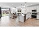 Open-concept living space with a view of the modern kitchen and backyard at 19407 W Pierson St, Litchfield Park, AZ 85340