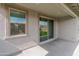 Covered patio with tan stucco, a window with blinds, and a large sliding glass door to the backyard at 19407 W Pierson St, Litchfield Park, AZ 85340