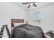 Modern bedroom with a dark bedding, a ceiling fan, and fitness equipment at 19806 W Marshall Ave, Litchfield Park, AZ 85340