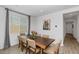 Elegant dining room with a large wooden table, seating for eight, and bright window at 19806 W Marshall Ave, Litchfield Park, AZ 85340