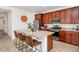 Well-lit kitchen boasts granite counters, stainless appliances, and an island with barstool seating at 19806 W Marshall Ave, Litchfield Park, AZ 85340