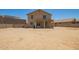 Large backyard featuring a covered patio, block fence, and ample space for various activities and customization at 21648 W Ashleigh Marie St, Buckeye, AZ 85326