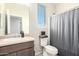 Bathroom featuring sink, toilet, shower, and window allowing natural light at 21648 W Ashleigh Marie St, Buckeye, AZ 85326