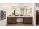 Bright bathroom with a double sink vanity, framed mirror and neutral color palette at 21648 W Ashleigh Marie St, Buckeye, AZ 85326