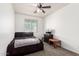 Comfortable bedroom with a ceiling fan, cozy carpet, and a large window for ample natural light at 21648 W Ashleigh Marie St, Buckeye, AZ 85326