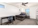 Bedroom featuring gray bed, desk and dark gray carpet at 21648 W Ashleigh Marie St, Buckeye, AZ 85326