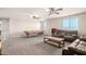 Spacious bonus room with dual ceiling fans, carpeted floors, and natural lighting at 21648 W Ashleigh Marie St, Buckeye, AZ 85326