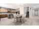 Well-lit kitchen with an island, seating, and stainless steel appliances, next to the stairs at 21648 W Ashleigh Marie St, Buckeye, AZ 85326