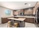 Kitchen features an island with bar seating, stainless steel appliances, and plenty of counter space at 21648 W Ashleigh Marie St, Buckeye, AZ 85326