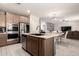 Spacious kitchen boasts lots of natural light, stainless appliances, and an open concept to the living room at 21648 W Ashleigh Marie St, Buckeye, AZ 85326