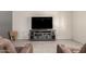 Cozy living room featuring a TV and a gray entertainment center for relaxing entertainment at 21648 W Ashleigh Marie St, Buckeye, AZ 85326