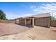 Large backyard featuring patio, gravel landscaping, and block wall at 22926 W Yavapai St, Buckeye, AZ 85326
