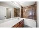 Primary bathroom featuring brown marble-look shower and white vanity at 22926 W Yavapai St, Buckeye, AZ 85326
