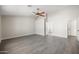 Bedroom featuring gray walls, laminate flooring, ceiling fan, and two entry doors at 22926 W Yavapai St, Buckeye, AZ 85326
