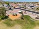 Community playground with colorful play structures, a shaded picnic area, and grassy fields at 22926 W Yavapai St, Buckeye, AZ 85326