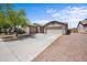 Inviting single-story home with a well-kept yard, long driveway and a three-car garage at 22926 W Yavapai St, Buckeye, AZ 85326