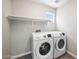 Bright laundry room featuring new white washer and dryer and a small window at 22926 W Yavapai St, Buckeye, AZ 85326