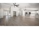 Open floor plan with living and kitchen areas, light wood-look floors and white trim throughout at 22926 W Yavapai St, Buckeye, AZ 85326