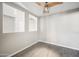 Room with gray walls, laminate flooring, ceiling fan, and an open space for the light fixture to show at 22926 W Yavapai St, Buckeye, AZ 85326