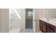 Bathroom featuring a shower and a double sink vanity with dark wood cabinets at 25138 W Chanute Pass, Buckeye, AZ 85326