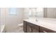 Bathroom featuring white countertops, dark cabinets, toilet, and bathtub-shower combo at 25138 W Chanute Pass, Buckeye, AZ 85326