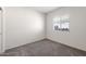Bedroom with neutral carpet, a window with blinds, and simple white walls at 25138 W Chanute Pass, Buckeye, AZ 85326