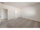 Bright bedroom with neutral carpet, white walls, and doorways that lead to the bathroom at 25138 W Chanute Pass, Buckeye, AZ 85326