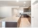 Spacious kitchen with a large center island, granite countertops, and stainless steel appliances at 25138 W Chanute Pass, Buckeye, AZ 85326