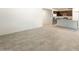 Open-concept living room with tile flooring that flows into a kitchen with stainless steel appliances and granite countertops at 25138 W Chanute Pass, Buckeye, AZ 85326