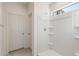 Shower with white fixtures, built-in shelving, and a small window at 25138 W Chanute Pass, Buckeye, AZ 85326