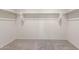 Walk-in closet with neutral carpet and white walls, providing ample storage space at 25138 W Chanute Pass, Buckeye, AZ 85326