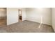 Carpeted bedroom with an attached bathroom with a neutral color palette at 25200 W Wier Ave, Buckeye, AZ 85326