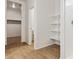 Bathroom features a walk-in closet, standing shelves, and a stand-up shower at 25235 N 183Rd Dr, Wittmann, AZ 85361