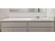 Bathroom vanity features white cabinets, white marbled counter, and chrome faucet at 25235 N 183Rd Dr, Wittmann, AZ 85361