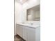 Bathroom with double vanity, white cabinets, white marbled counter, and chrome faucets at 25235 N 183Rd Dr, Wittmann, AZ 85361