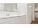 Bathroom features dual sinks, white cabinets, and tile floors at 25235 N 183Rd Dr, Wittmann, AZ 85361