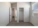 Bright bedroom featuring neutral carpet, a window, closet and attached bath at 25235 N 183Rd Dr, Wittmann, AZ 85361