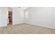 Bedroom features neutral colored carpet, a door and a window at 25235 N 183Rd Dr, Wittmann, AZ 85361