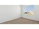 Carpeted bedroom featuring a bright window with blinds offering neighborhood views at 25235 N 183Rd Dr, Wittmann, AZ 85361