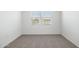 A bedroom has neutral carpet with a single window providing ample sunlight at 25235 N 183Rd Dr, Wittmann, AZ 85361