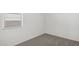 Bright bedroom with neutral carpet, baseboard, window and neutral paint at 25235 N 183Rd Dr, Wittmann, AZ 85361