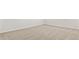 Close up of the bedroom floor with neutral colored carpet and white baseboards at 25235 N 183Rd Dr, Wittmann, AZ 85361