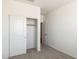 Bedroom with neutral carpet features closet with sliding doors and an open doorway at 25235 N 183Rd Dr, Wittmann, AZ 85361