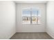 Carpeted bedroom features a window with blinds allowing natural light to filter through at 25235 N 183Rd Dr, Wittmann, AZ 85361